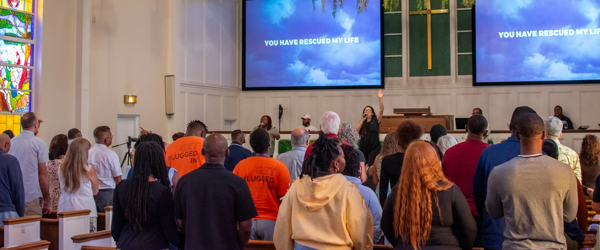 The congregation singing together during Sunday worship