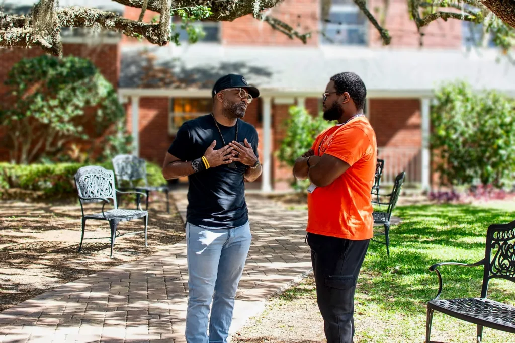 Two men talking together in the church courtyard